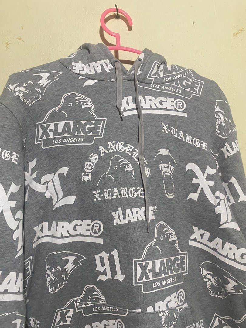X-Large All Over Print Hoodie (Category: Hoodies) located in Manila. Submitted by bapekiddos (Listing ID 1444811844, Image 2). Description: - Grey X-Large hoodie - All-over repeating print featuring X-Large logo, gorilla graphic, and 'Los Angeles' text - Long sleeves with ribbed cuffs - Front kangaroo pocket - Comfortable and stylish streetwear piece.