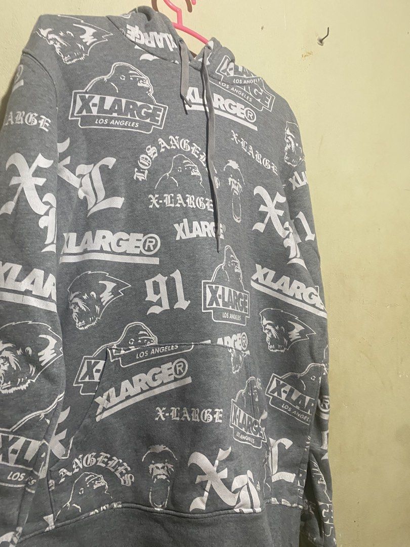 X-Large All Over Print Hoodie (Category: Hoodies) located in Manila. Submitted by bapekiddos (Listing ID 1444811844, Image 3). Description: - Grey X-Large hoodie - All-over repeating print featuring X-Large logo, gorilla graphic, and 'Los Angeles' text - Long sleeves with ribbed cuffs - Front kangaroo pocket - Comfortable and stylish streetwear piece.