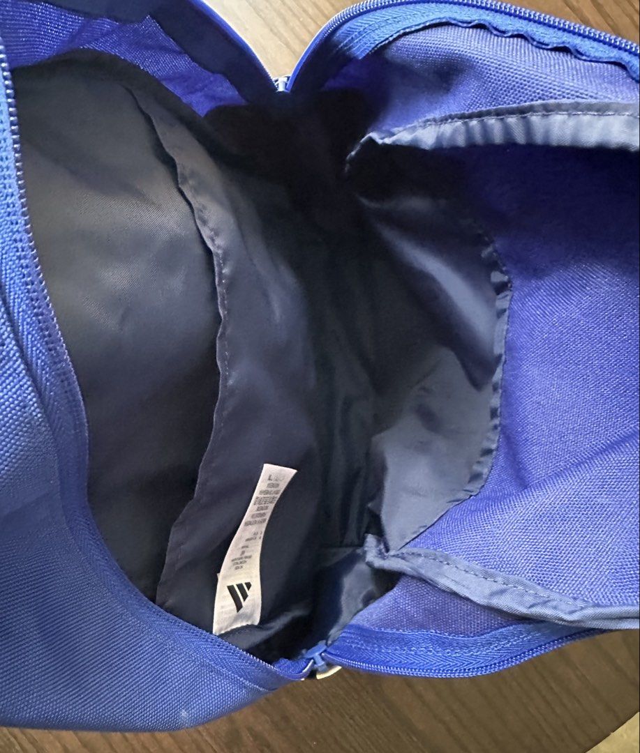 Adidas Logo Backpack - Blue (Category: Backpacks) located in Singapore. Submitted by happydeecee (Listing ID 1441400745, Image 3). Description: - Adidas Logo Backpack - Iconic white stripes on the side - Adidas logo on the front pocket - Main compartment for storage - Front zip pocket for essentials - Adjustable shoulder straps for comfort - Ideal for school or everyday use.