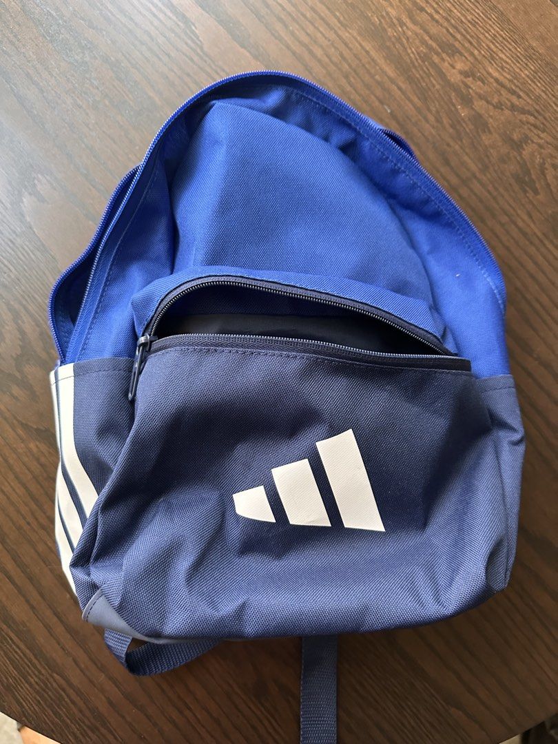 Adidas Logo Backpack - Blue (Category: Backpacks) located in Singapore. Submitted by happydeecee (Listing ID 1441400745, Image 1). Description: - Adidas Logo Backpack - Iconic white stripes on the side - Adidas logo on the front pocket - Main compartment for storage - Front zip pocket for essentials - Adjustable shoulder straps for comfort - Ideal for school or everyday use.