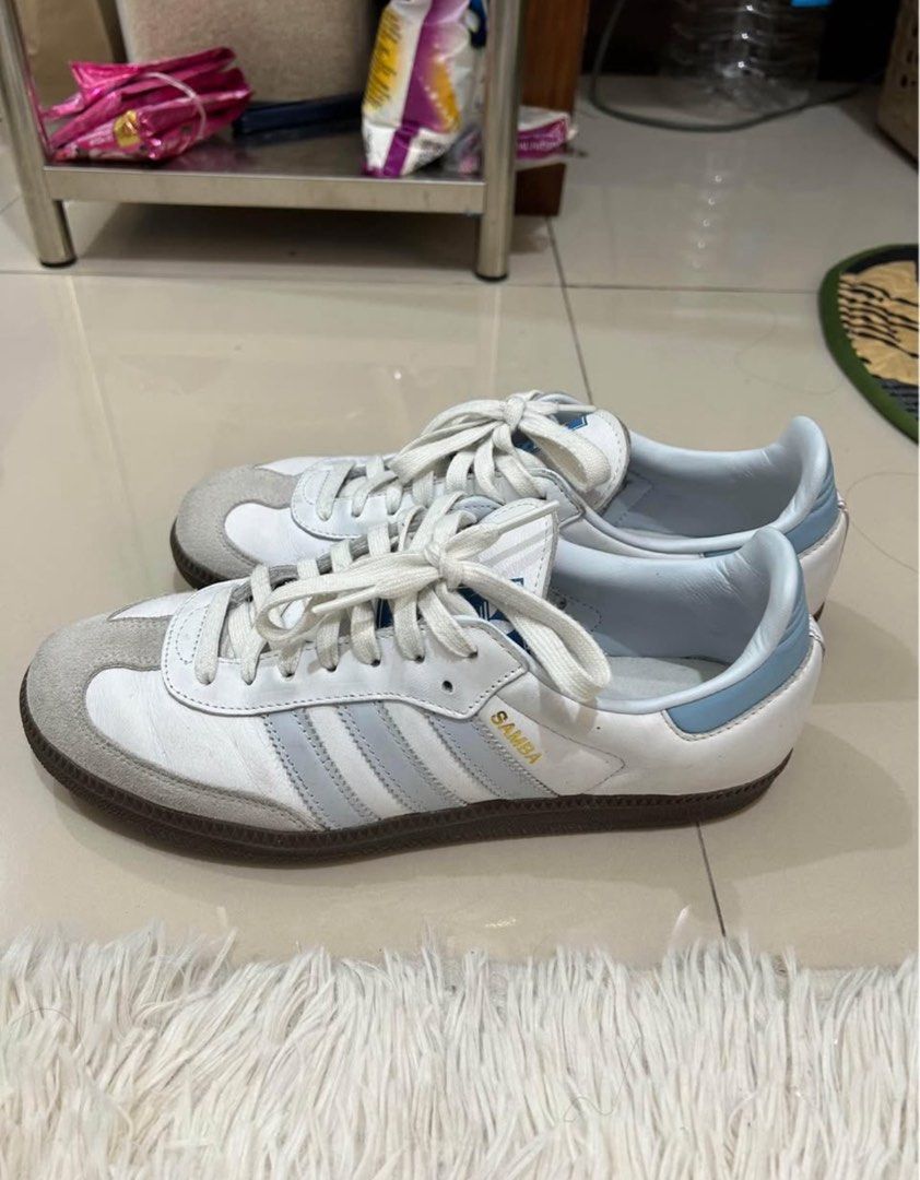 Adidas Samba White Light Blue Stripes Sneakers (Category: Sneakers) located in Manila. Submitted by hello_lilies (Listing ID 1441521541, Image 1). Description: - Classic Adidas Samba sneakers - White leather with iconic light blue stripes - Durable gum sole - Perfect for everyday style and a sneaker essential - Pre-loved with plenty of wear remaining.