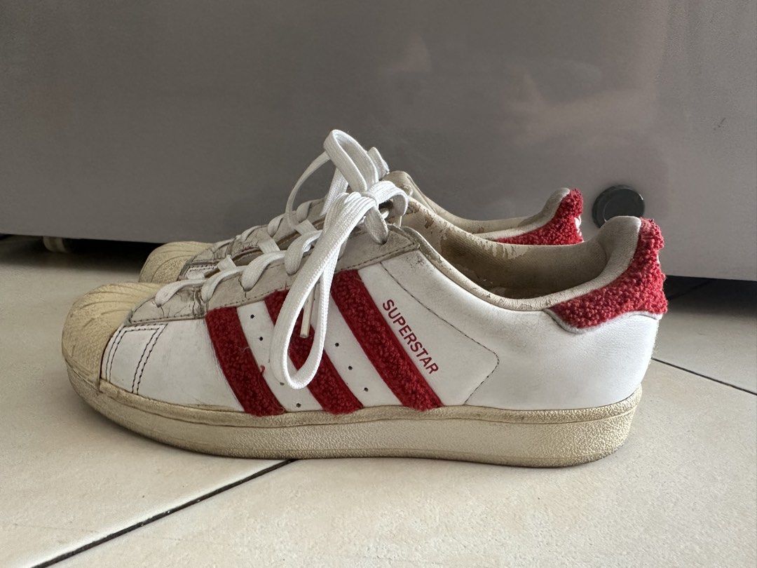 Adidas Superstar White Red Sneakers (Category: Sneakers) located in Mandaluyong City. Submitted by miaaaa32 (Listing ID 1441420602, Image 2). Description: - Classic Adidas Superstar sneakers - White leather with iconic red stripes - Unique fuzzy trim detail (limited edition) - Signature shell toe design - Perfect for everyday casual style -Has signs of use but no issues (slipping, cracks) - Sold as is Open to nego Return and refund only if produc