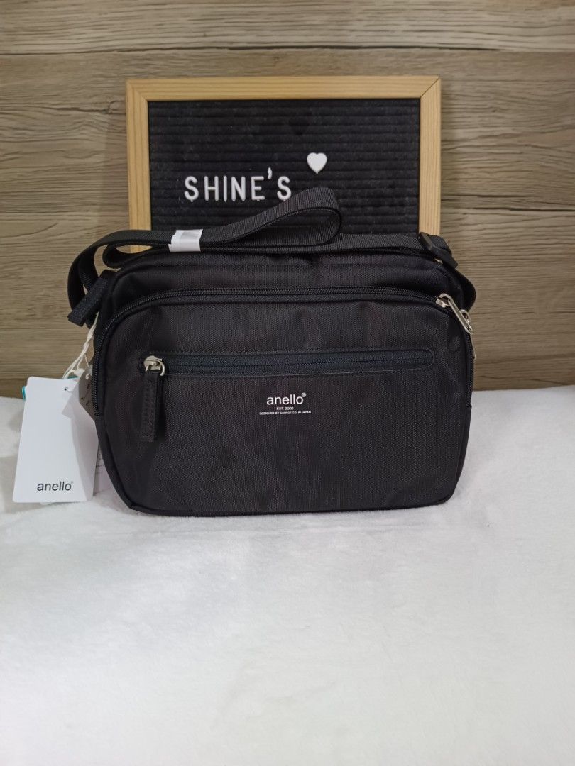 Anello Black Nylon Crossbody Bag (Category: Cross-body Bags) located in Quezon City. Submitted by shinereign (Listing ID 1441400619, Image 1). Description: - Authentic Anello crossbody bag in classic black. - Crafted from durable, high-quality nylon. - Convenient front zip pocket for quick access. - Spacious main compartment to hold your essentials. - Adjustable strap for a customized, comfortable fit. - Brand new with original tags still attache
