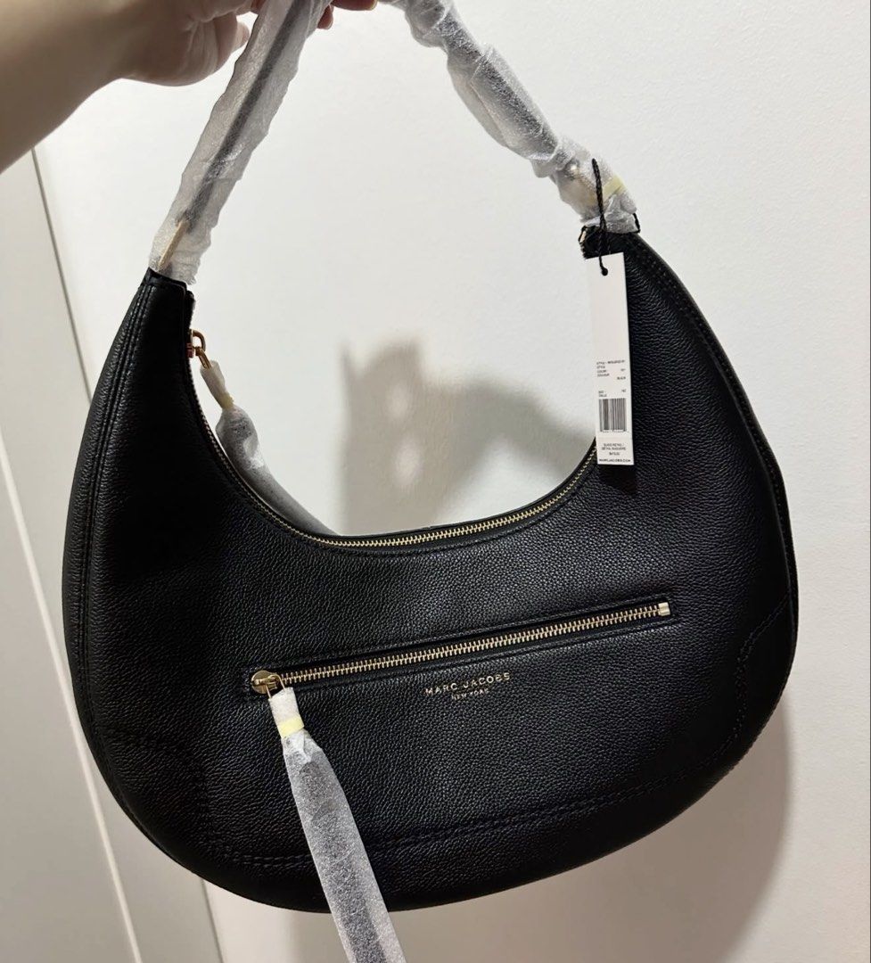 Authentic Marc Jacobs Black Leather Oversized Hobo Bag (Category: Luxury Bags & Wallets) located in Quezon City. Submitted by aprillovestoshop (Listing ID 1441562376, Image 3). Description: RUSH!! Bnew with tag! Auth Marc Jacobs Oversized hobo in black. P12,500 ONLY!! (Retails for 30k+) 🔥 - Authentic Marc Jacobs black leather hobo bag - Features a secure zip-around closure - Convenient front zip pocket - Elegant gold-tone hardware - Comes with o