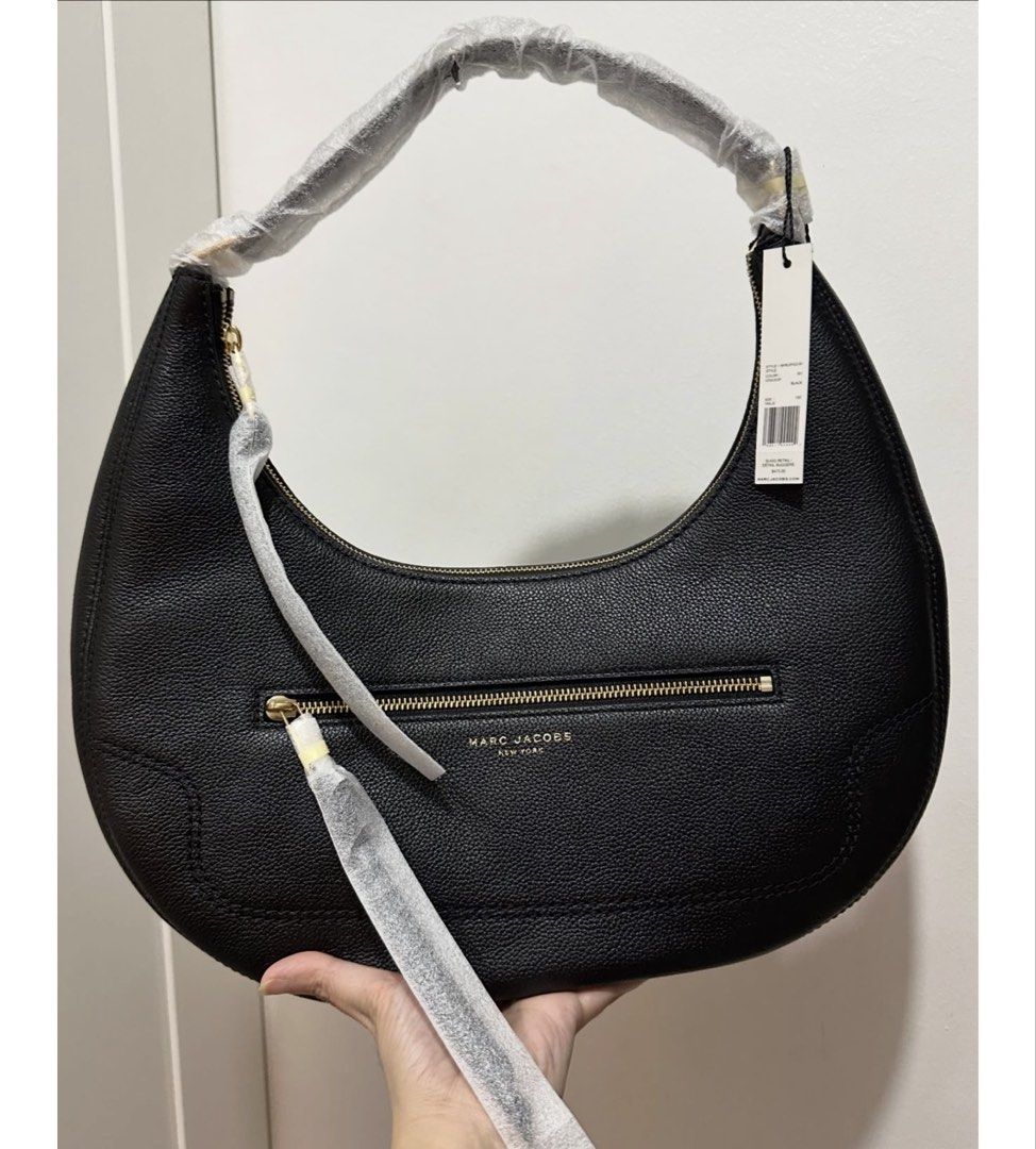 Authentic Marc Jacobs Black Leather Oversized Hobo Bag (Category: Luxury Bags & Wallets) located in Quezon City. Submitted by aprillovestoshop (Listing ID 1441562376, Image 1). Description: RUSH!! Bnew with tag! Auth Marc Jacobs Oversized hobo in black. P12,500 ONLY!! (Retails for 30k+) 🔥 - Authentic Marc Jacobs black leather hobo bag - Features a secure zip-around closure - Convenient front zip pocket - Elegant gold-tone hardware - Comes with o