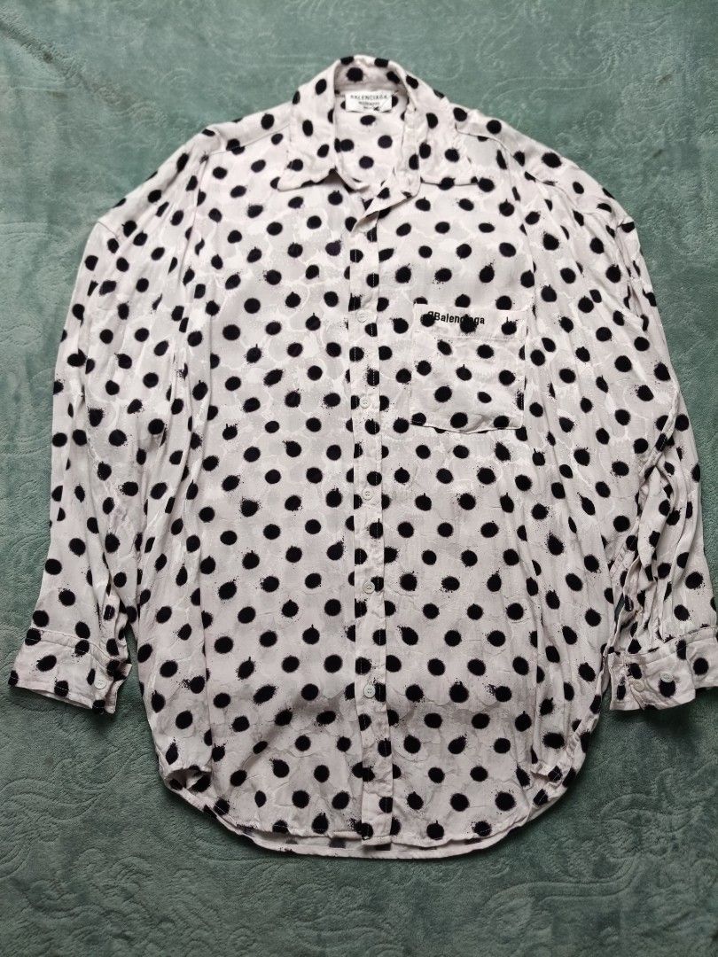 Balenciaga Polka Dot Shirt (Category: Luxury Apparel) located in Valenzuela. Submitted by 2ndhandmarket.ph (Listing ID 1441515693, Image 1). Description: - Classic white shirt with stylish black polka dots. - Authentic Balenciaga logo detail on the chest pocket and tag. - Expertly crafted in France. - Versatile button-up style. - Designed for a comfortable, relaxed fit. Size: Small oversized Can fit upto XXL Width: 27 Length: 30 Need wash only..