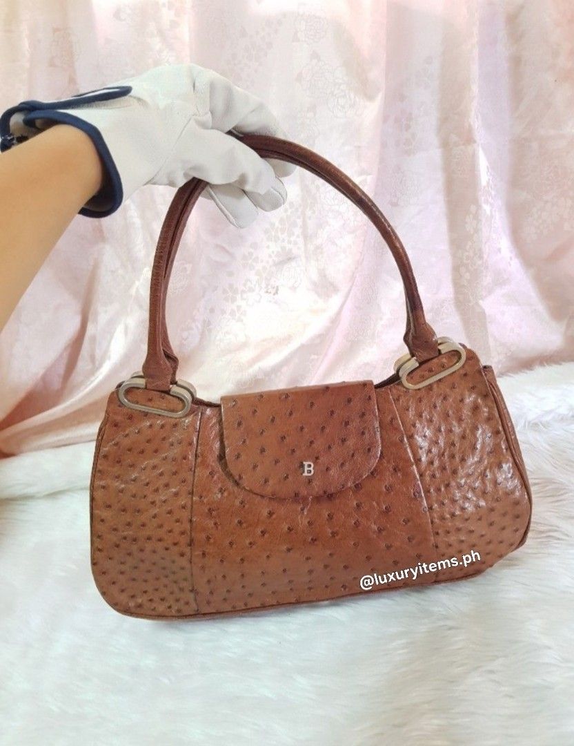 Bally Ostrich Leather Shoulder Bag (Category: Luxury Bags & Wallets) located in Pamplona. Submitted by luxuryitems_ph (Listing ID 1441514060, Image 1). Description: - Genuine brown ostrich leather shoulder bag - Features a flap closure with a subtle 'B' logo - Distinctive textured leather finish - Comfortable, well-sized handles for carrying - A timeless addition to any handbag collection -Rare piece.