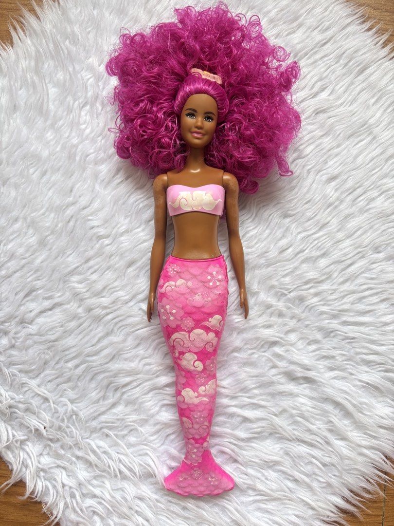 Barbie Color Reveal Preloved (Category: Kids Toys) located in Bulacan. Submitted by lmsdeclutteringcorner (Listing ID 1441422394, Image 1). Description: - Mermaid Barbie doll - Vibrant pink curly hair - Pink bikini top - Pink tail with cloud and flower patterns - Shimmery tail finish - Ideal for imaginative play - Great for collectors - Ready for underwater adventures - ISSUE: wala na yung pinaka dulo ng tail.