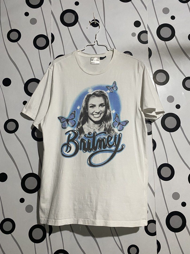 Britney Spears Shirt (Category: Shirts) located in Cebu City. Submitted by patspickph (Listing ID 1441530470, Image 1). Description: This white Britney Spears vintage-style t-shirt features a blue airbrushed graphic of the singer surrounded by blue butterflies. W20.5 L28.5 Excellent Condition.