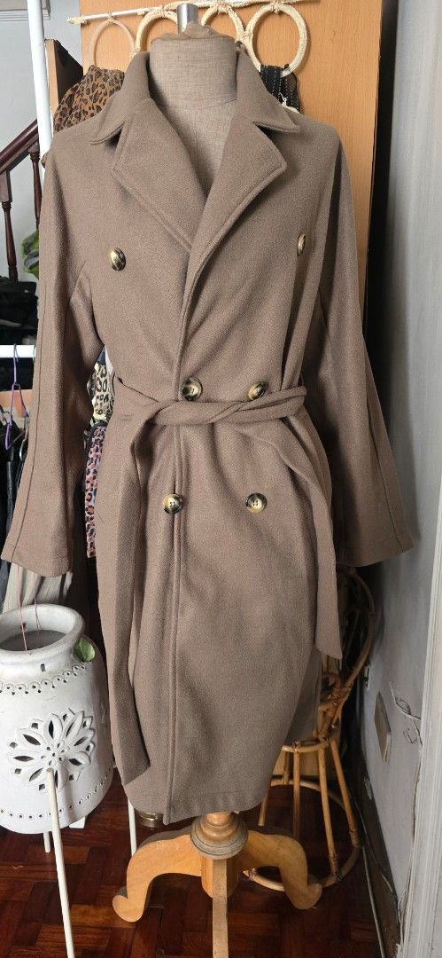 Brown Double-Breasted Trench Coat with Belt (Category: Coats, Jackets and Outerwear) located in Manila. Submitted by foxydivas (Listing ID 1441395574, Image 2). Description: - Brand new. selling it 50% off from orig price - Classic brown trench coat - Double-breasted style - Features elegant gold buttons - Includes a matching belt to cinch the waist - Versatile: wear open or closed - Ideal for cooler weather rfs: bought double.