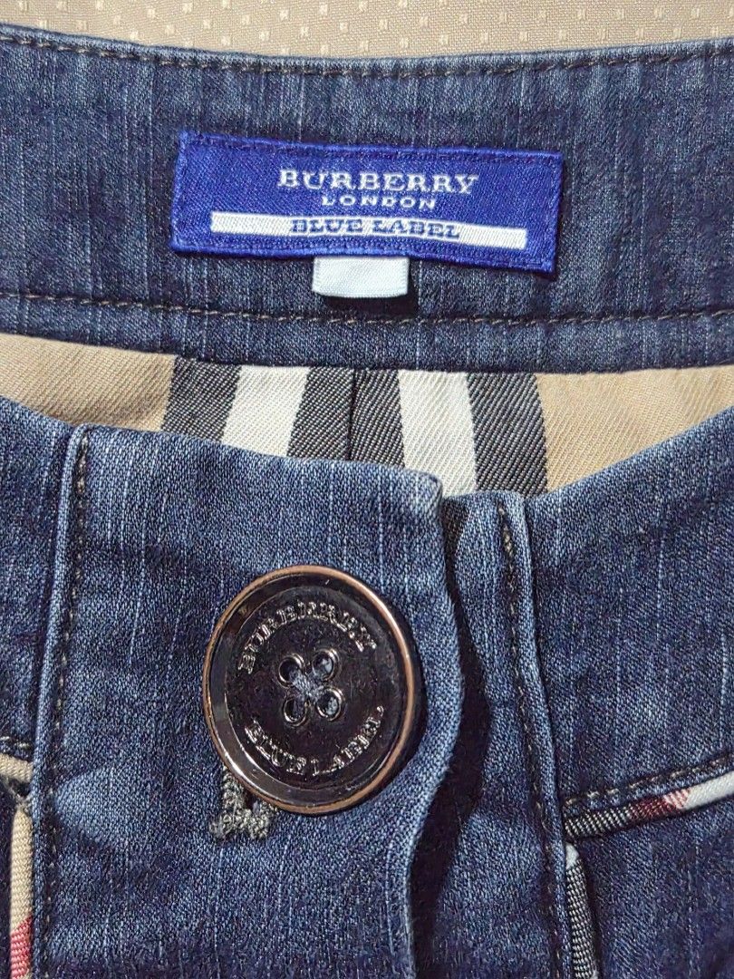 Burberry Blue Label Denim Dress with Buckle Detail - Size M (Category: Makeup) located in Mandaue City. Submitted by chuchi152615 (Listing ID 1441447742, Image 3). Description: - Burberry Blue Label denim dress with flaws missing one button - Classic blue wash with contrast stitching - Belted waist with a metal buckle - Button-up front with unique multi-colored buttons - Short sleeves - Ideal for casual wear.