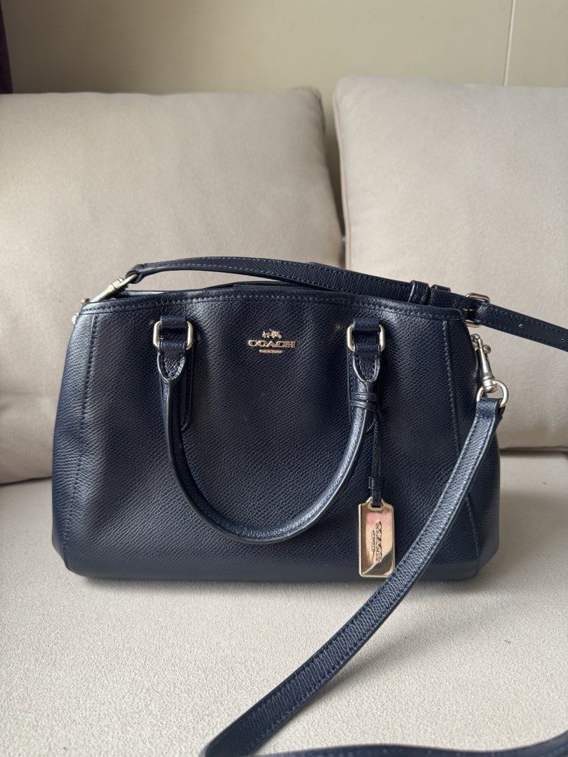 Coach Margot Navy Pebbled Leather Satchel Bag (Category: Luxury Bags & Wallets) located in Makati City. Submitted by ayeshadeclutters (Listing ID 1441442607, Image 2). Description: - Navy blue Coach satchel bag - Pebbled leather exterior - Gold hardware - Top handles - Detachable crossbody strap - Interior zippered pocket - Interior slip pockets - Clean inside and out - Perfect everyday bag.