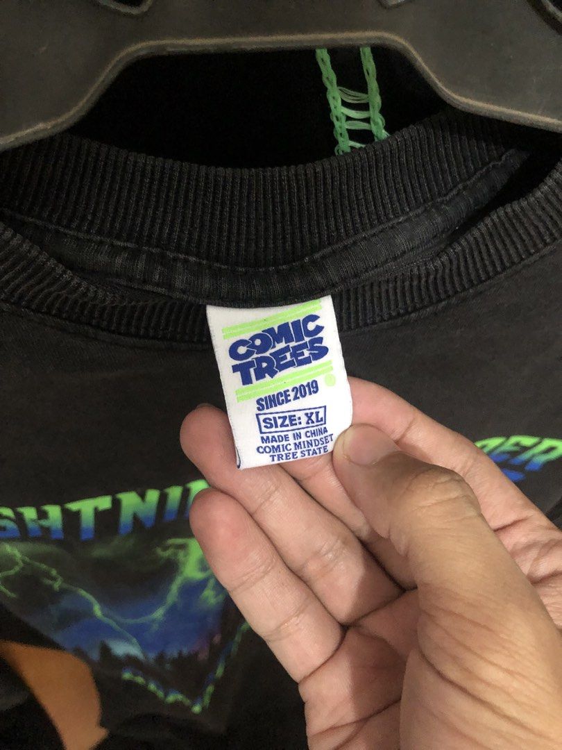 Comic Trees Lightning Thunder Night T-shirt XL (Category: Tshirts & Polo Shirts ) located in Bulacan. Submitted by thrifted.master (Listing ID 1441401714, Image 3). Description: - Brand: Comic Trees - Design: Lightning and forest graphic - Text: 'Lightning Thunder Night', 'Comic Trees Studio' - Size: XL - Origin: Made in China - Measurements: Length 31.5 inches, Width 24 inches.
