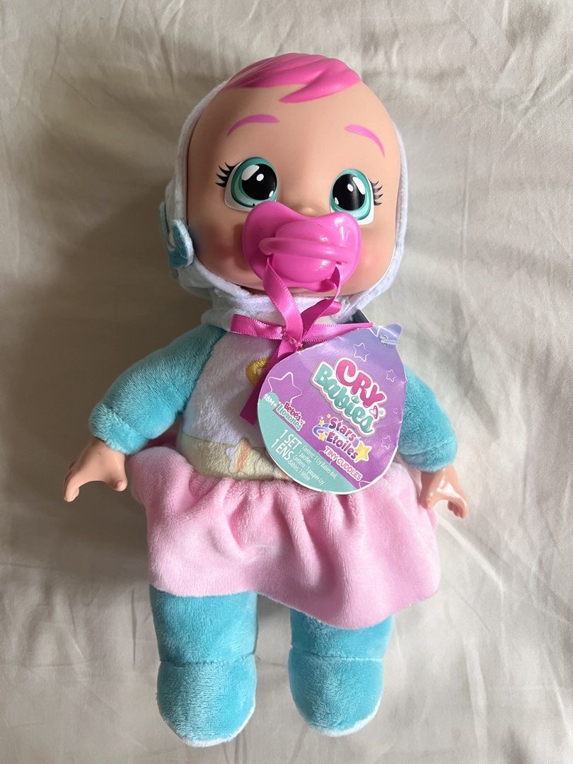 Cry Babies Stars Tiny Cuddles Doll with Pacifier (Category: Toys & Games) located in Muntinlupa City. Submitted by psm.seconds (Listing ID 1441583558, Image 1). Description: .