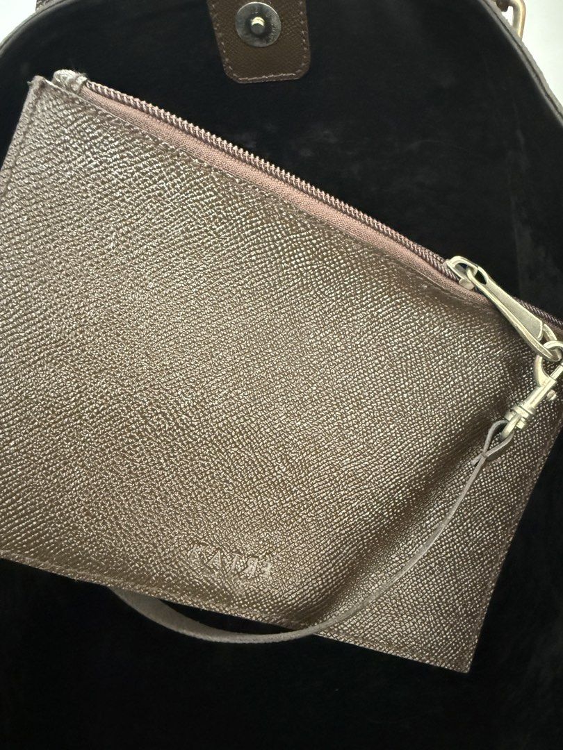 Dark Brown Textured Tote Bag with Pouch (Category: Tote Bags) located in Quezon City. Submitted by reivia.vend (Listing ID 1441426604, Image 2). Description: - Stylish dark brown textured tote bag - Includes a matching inner pouch with zipper closure - Two comfortable top handles - Attached luggage tag with initials 'ARVC' (removable) - Ideal for everyday errands or professional settings.