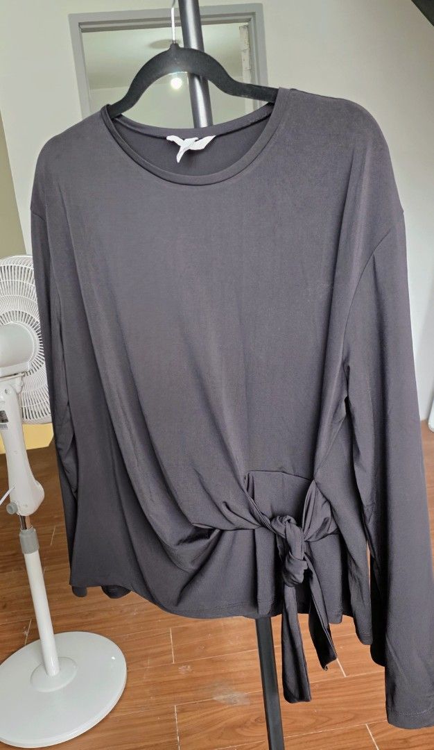 Dark Grey Long Sleeve Top with Tie Front (Category: Longsleeves) located in Mandaluyong City. Submitted by deverarose (Listing ID 1441389357, Image 1). Description: - Comfy dark grey long sleeve top - Features a tie detail at the front waist - Made from a soft, drapey fabric - Ideal for casual wear or layering - Versatile for styling up or down.