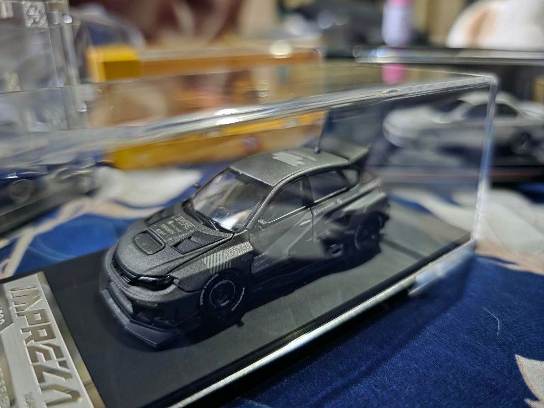 Diecast Subaru Impreza WRX STI Model Car (Category: Vehicle & Diecast Models) located in Caloocan City. Submitted by yaeikko (Listing ID 1441450082, Image 1). Description: Sealed, Complete - 1:64 scale model of the Subaru Impreza WRX STI - Features a striking wide body kit - Equipped with a large, aggressive rear spoiler - Comes in a clear display case for protection and presentation - Base is marked with 'IMPREZA' - Ideal addition for any car mo