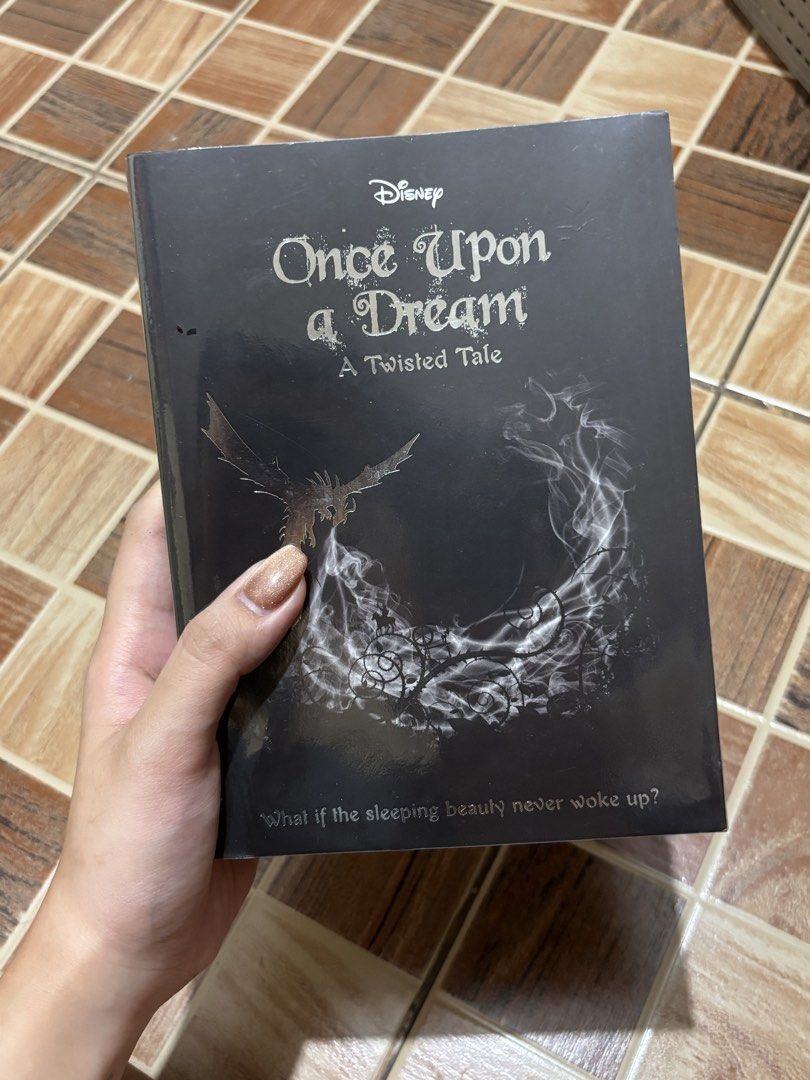 Disney Once Upon a Dream A Twisted Tale Book (Category: Storybooks) located in Bulacan. Submitted by prelovedbyjoana (Listing ID 1441558098, Image 1). Description: - Disney 'Once Upon a Dream' book - Part of the 'A Twisted Tale' series - Explores the 'What if' scenario: What if Sleeping Beauty never woke up? - Ideal for Disney fans who enjoy darker twists on classic fairy tales - A great addition to any book collection.