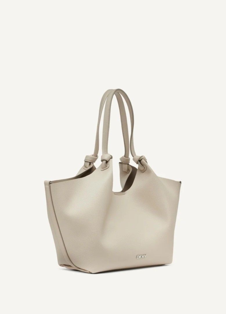DKNY Beige Tote Bag with Pouch (Category: Tote Bags) located in Baguio. Submitted by msgold2601 (Listing ID 1441576430, Image 2). Description: - Beige DKNY tote bag - Includes matching pouch - Slouchy, open-top design - Knotted handles - Ample interior space - Ideal for daily use.
