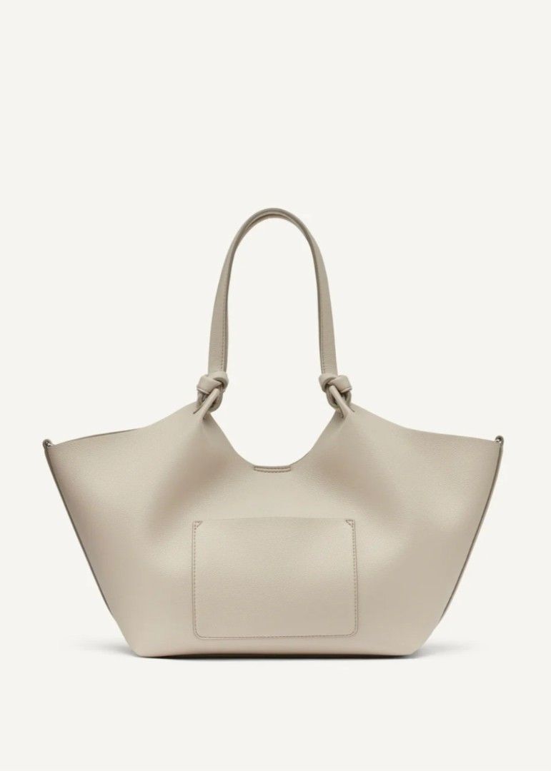 DKNY Beige Tote Bag with Pouch (Category: Tote Bags) located in Baguio. Submitted by msgold2601 (Listing ID 1441576430, Image 3). Description: - Beige DKNY tote bag - Includes matching pouch - Slouchy, open-top design - Knotted handles - Ample interior space - Ideal for daily use.