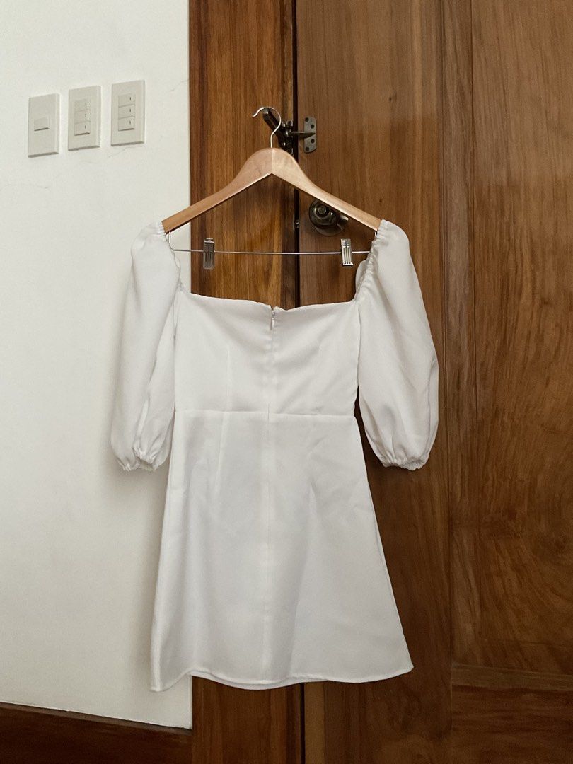 Eze White Puff Sleeve Square Neck Mini Dress (Category: Dresses) located in Iloilo. Submitted by maecha (Listing ID 1441381596, Image 3). Description: - White mini dress - Puff sleeves - Square neckline - Back zipper closure - Simple and chic design - Ideal for parties or a night out - Comfortable and flattering fit.