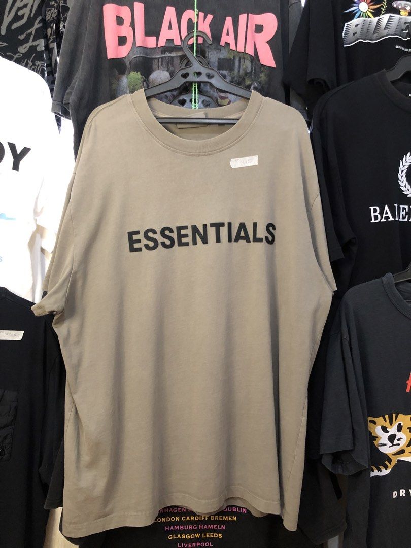 Fear of God Essentials T-shirt Taupe (Category: Tshirts & Polo Shirts ) located in Bulacan. Submitted by thrifted.master (Listing ID 1441402714, Image 1). Description: - Brand: Fear of God Essentials - Color: Taupe - Design: Classic t-shirt with Essentials logo on the front - Condition: Good - Style: Ideal for everyday casual wear.