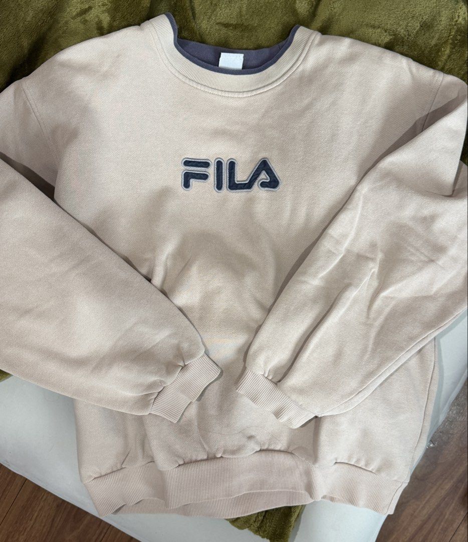 Fila Sweatshirt Beige Crewneck Pullover Size S (Category: Coats, Jackets and Outerwear) located in Manila. Submitted by chamyto_ (Listing ID 1441564023, Image 1). Description: - Classic Fila sweatshirt - Color: Beige with navy blue logo - Style: Crewneck - Size: Tagged S (fits like S) - Measurements: Chest width 21", Length 24" - Ideal for casual wear.