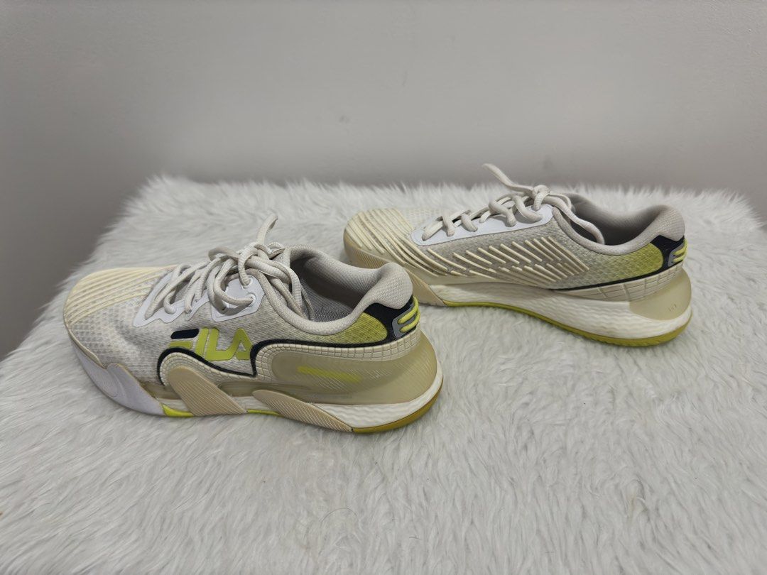 Fila White & Yellow Athletic Shoes (Original) (Category: Sneakers) located in Manila. Submitted by mingmingtsu_ (Listing ID 1441425147, Image 3). Description: Worn by a 37W - White and yellow Fila athletic shoes - Lace-up closure - Size: 6.5 US / 37.5 EUR / 235 CM - Ideal for running or training - Minor scuffs on soles and toe area.