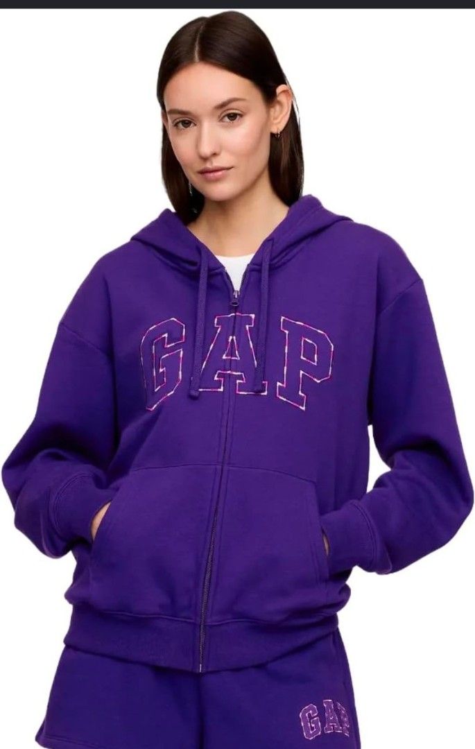 GAP Purple Zip-Up Hoodie (Category: Hoodies) located in Quezon City. Submitted by shinereign (Listing ID 1441439299, Image 2). Description: - Purple zip-up hoodie from GAP - Features classic GAP logo with pink and white checkered fill across the chest - Drawstring hood for adjustable comfort - Convenient front pockets - Ideal for everyday casual wear.