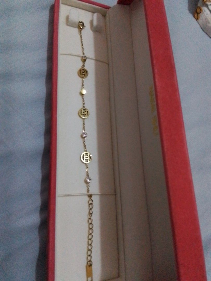 Gold Tone CC Charm Bracelet with Crystals (Category: Bracelets) located in Manila. Submitted by sakinto (Listing ID 1441526696, Image 3). Description: - Gold tone bracelet - Features iconic CC logo charms - Accented with small clear crystals and beads - Comes with a beautiful red jewelry box - Secure clasp closure with an extender chain for adjustable fit.