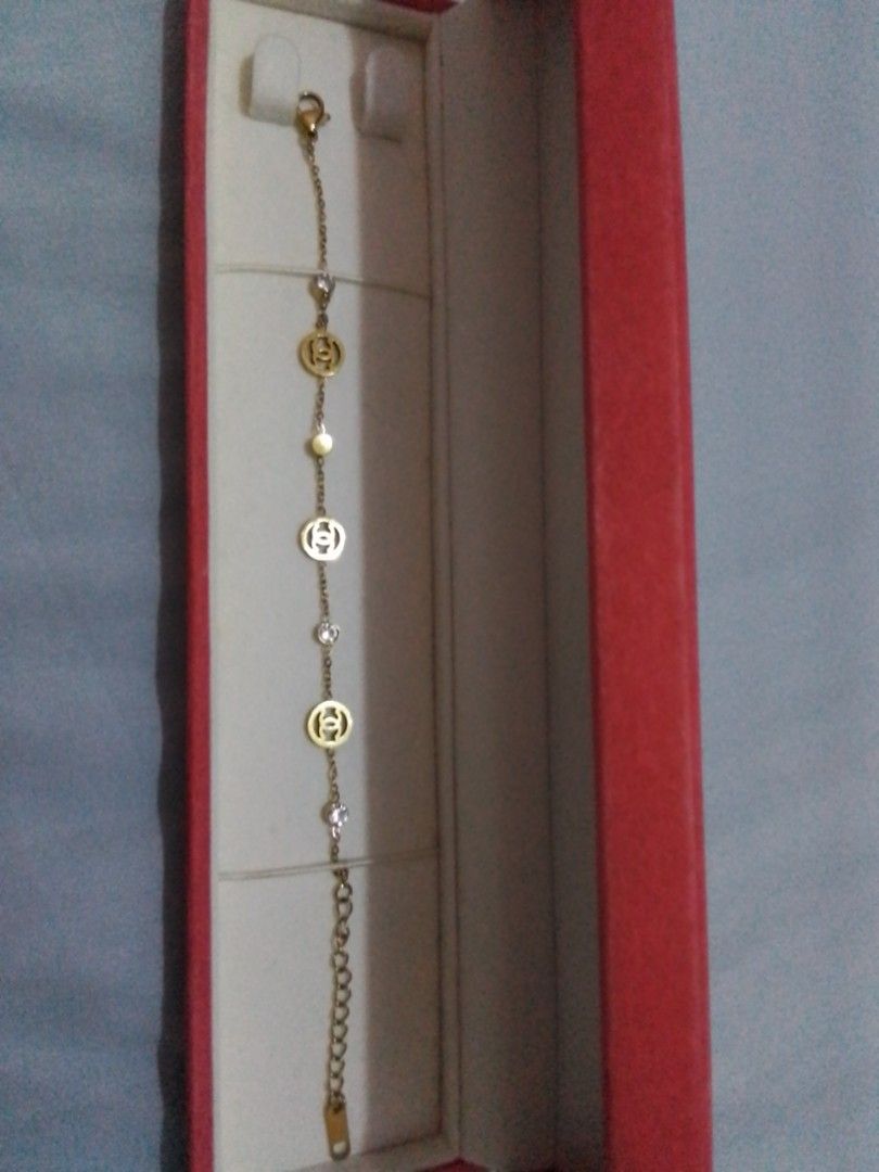 Gold Tone CC Charm Bracelet with Crystals (Category: Bracelets) located in Manila. Submitted by sakinto (Listing ID 1441526696, Image 1). Description: - Gold tone bracelet - Features iconic CC logo charms - Accented with small clear crystals and beads - Comes with a beautiful red jewelry box - Secure clasp closure with an extender chain for adjustable fit.