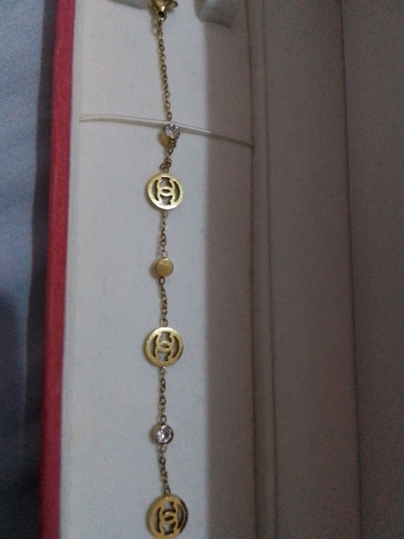 Gold Tone CC Charm Bracelet with Crystals (Category: Bracelets) located in Manila. Submitted by sakinto (Listing ID 1441526696, Image 2). Description: - Gold tone bracelet - Features iconic CC logo charms - Accented with small clear crystals and beads - Comes with a beautiful red jewelry box - Secure clasp closure with an extender chain for adjustable fit.