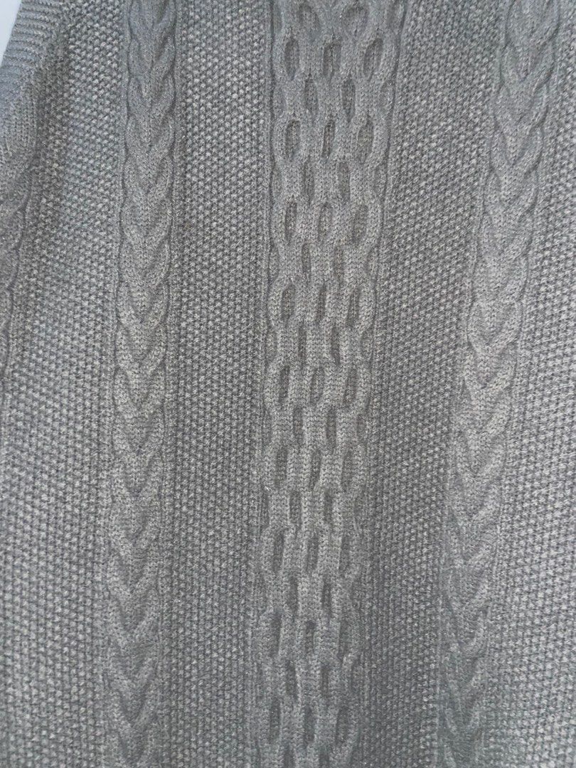 Grey Cable Knit Sleeveless Long Sweater Vest (Category: Sleeveless) located in Baguio. Submitted by everafterbgo (Listing ID 1441548643, Image 3). Description: - Long grey cable knit sweater vest - Sleeveless design - Unique strap details on the sides - Ideal for layering over tops or dresses - Cozy and stylish for cooler weather.