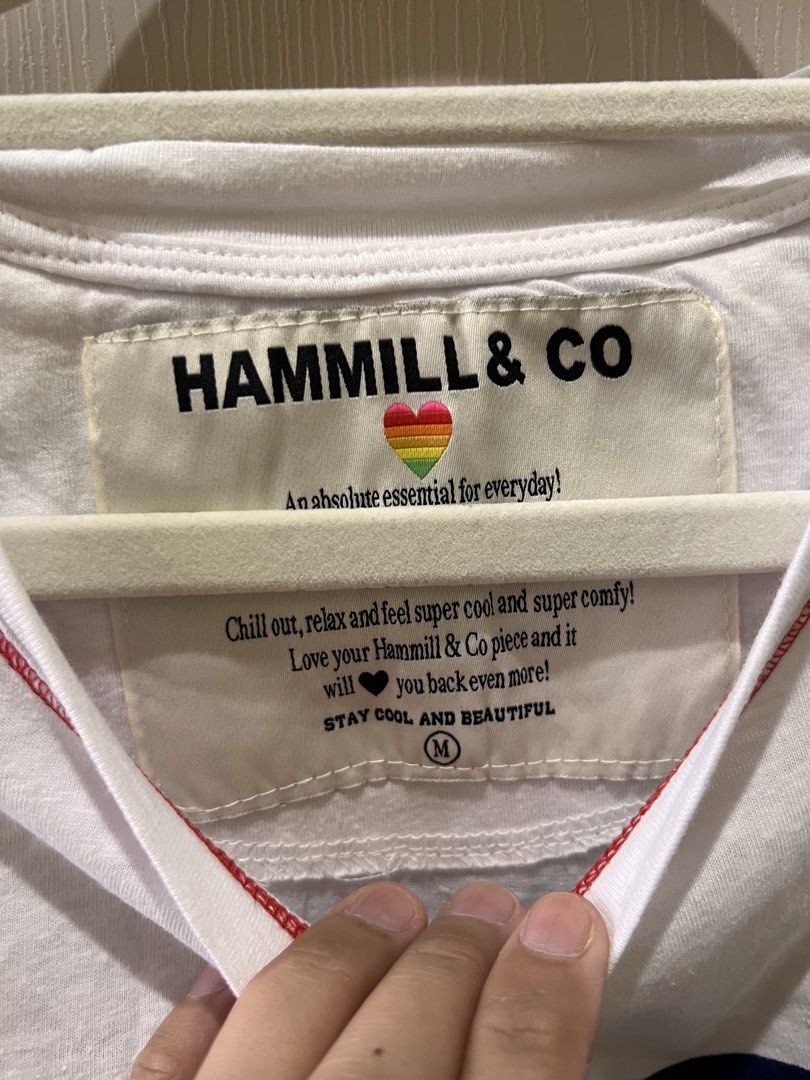 (Hammill & Co) White Heart Tank Top Size M (Category: Shirts) located in Angono. Submitted by elyenitty_ (Listing ID 1441501100, Image 2). Description: - White Hammill & Co tank top - Features a large navy blue heart graphic on the front - Red contrast stitching along the seams - Small 'H+C' logo detail on the hem - Super comfy and casual - Great for everyday wear.