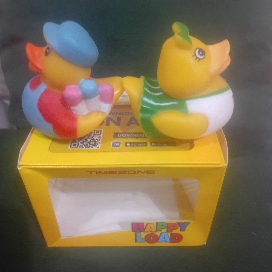 Happy Load Rubber Ducks with Box Timezone Collectibles (Category: Designer & Blind Box Toys) located in Silang. Submitted by trish125 (Listing ID 1441401010, Image 2). Description: - Adorable pair of rubber ducks - One duck dressed as a baby (diaper & bib) - Second duck in overalls & hat - Comes in a yellow "Happy Load" box with display window (has dents) - Includes a "Hope this puts a smile on your face" smiley card - Ideal for collectors or as 