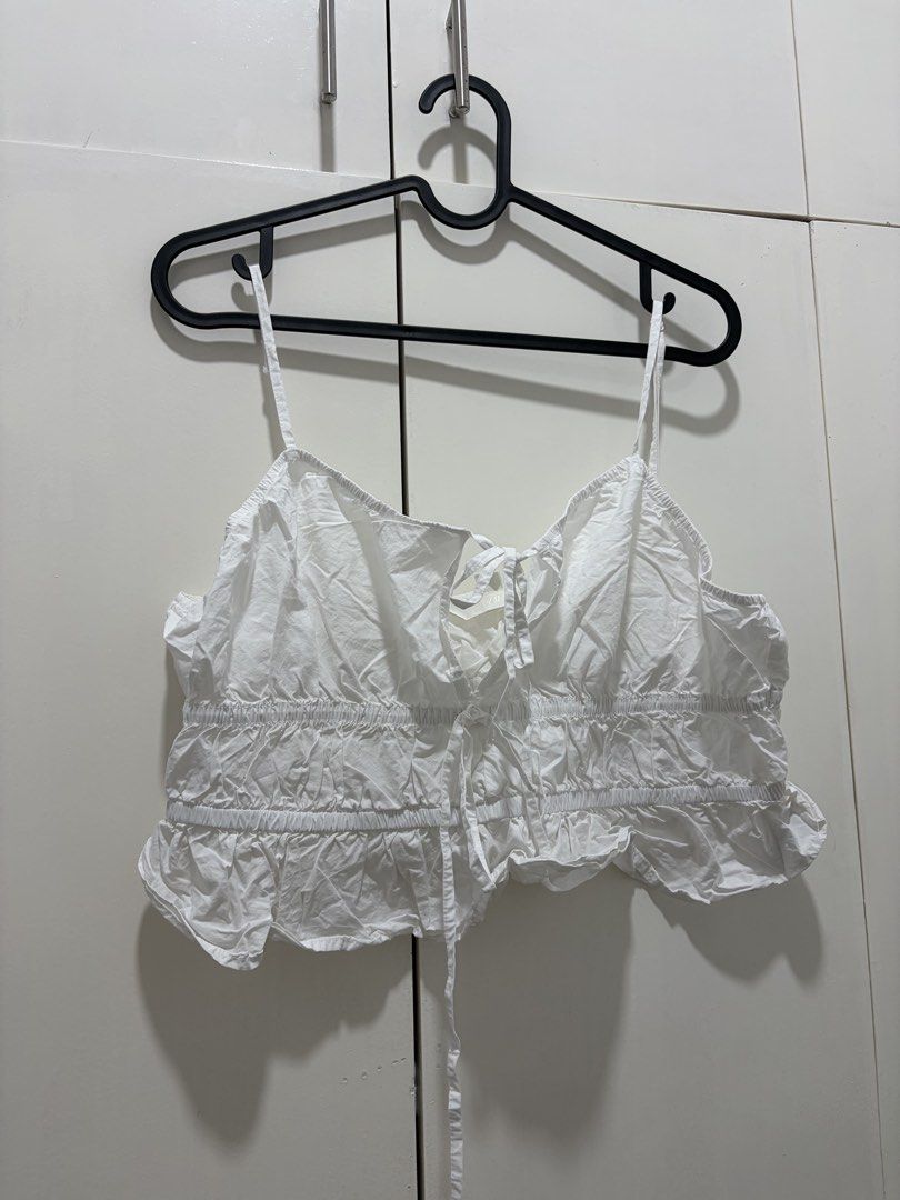 H&M White Tie-Front Cropped Top Size L (Category: Blouses) located in Pateros City. Submitted by dendenden15 (Listing ID 1441505067, Image 1). Description: - White tie-front cropped top from H&M - Features a ruffled hem - Adjustable tie detail at the bust - Spaghetti straps - Cute and breezy, perfect for summer - Easy to pair with shorts or skirts.
