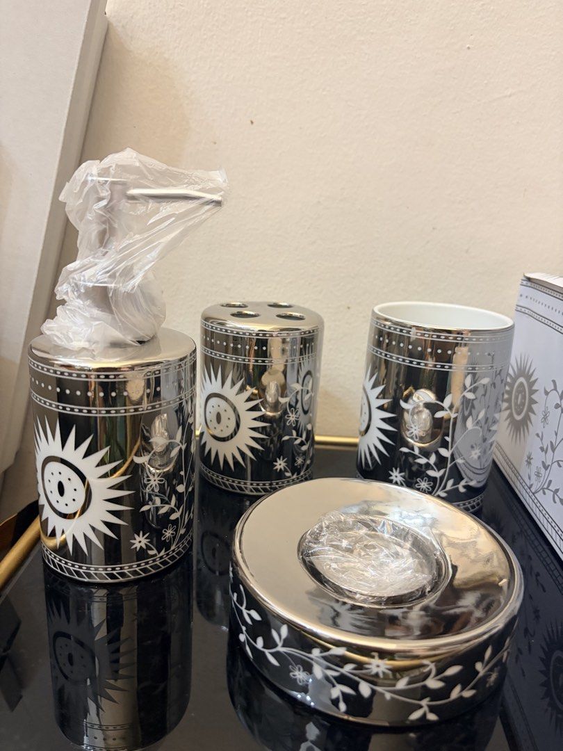 Home box UAE 4pcs set ceramic bathroom stuff (Category: Bathtub & Bath Accessories) located in Mandaluyong City. Submitted by home_box.ae (Listing ID 1441433557, Image 3). Description: This Kookee 4-piece ceramic bathroom set features a distinctive monochrome floral and sunburst design.