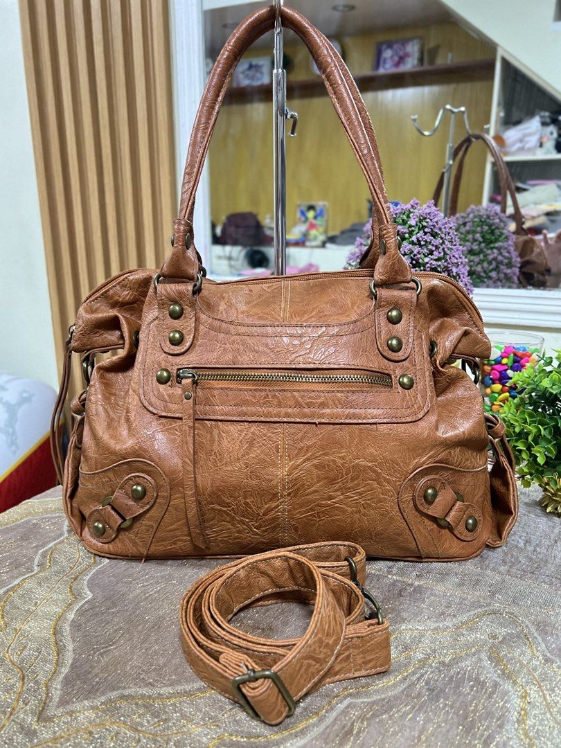 HUSHHUSH genuine leather two way bag (Category: Shoulder Bags) located in Lapu Lapu. Submitted by glamorouslybeautiful8.0 (Listing ID 1441474836, Image 1). Description: ☘️👜♥️HUSH•HUSH distressed leather two way crossbody bag inspired by classic BaLen Motorcycle🤎🤎🤎 PreL🌸ved whooaaahhh superb unique and gorgeous piece‼️‼️ med to large (LwH:15x5x10inches) ⚡️⚡️RARE⚡️⚡️MUST HAVE💕💕 This brown leather handbag features a distinctive distressed fin