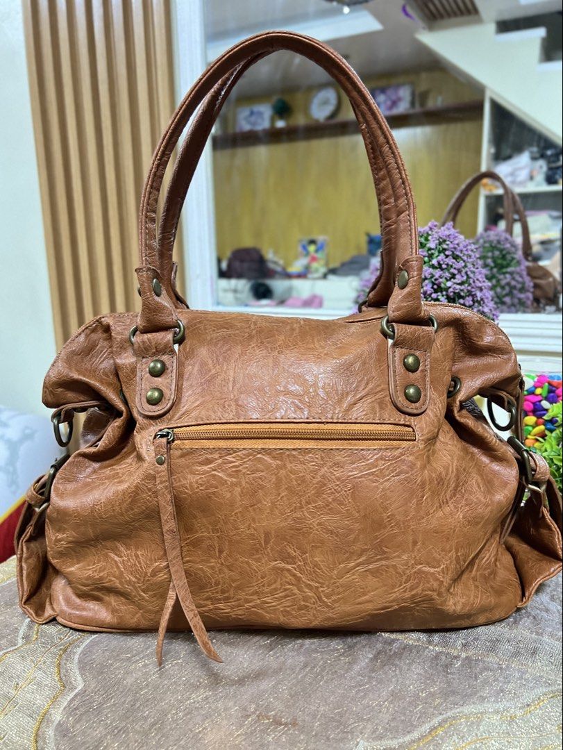 HUSHHUSH genuine leather two way bag (Category: Shoulder Bags) located in Lapu Lapu. Submitted by glamorouslybeautiful8.0 (Listing ID 1441474836, Image 3). Description: ☘️👜♥️HUSH•HUSH distressed leather two way crossbody bag inspired by classic BaLen Motorcycle🤎🤎🤎 PreL🌸ved whooaaahhh superb unique and gorgeous piece‼️‼️ med to large (LwH:15x5x10inches) ⚡️⚡️RARE⚡️⚡️MUST HAVE💕💕 This brown leather handbag features a distinctive distressed fin