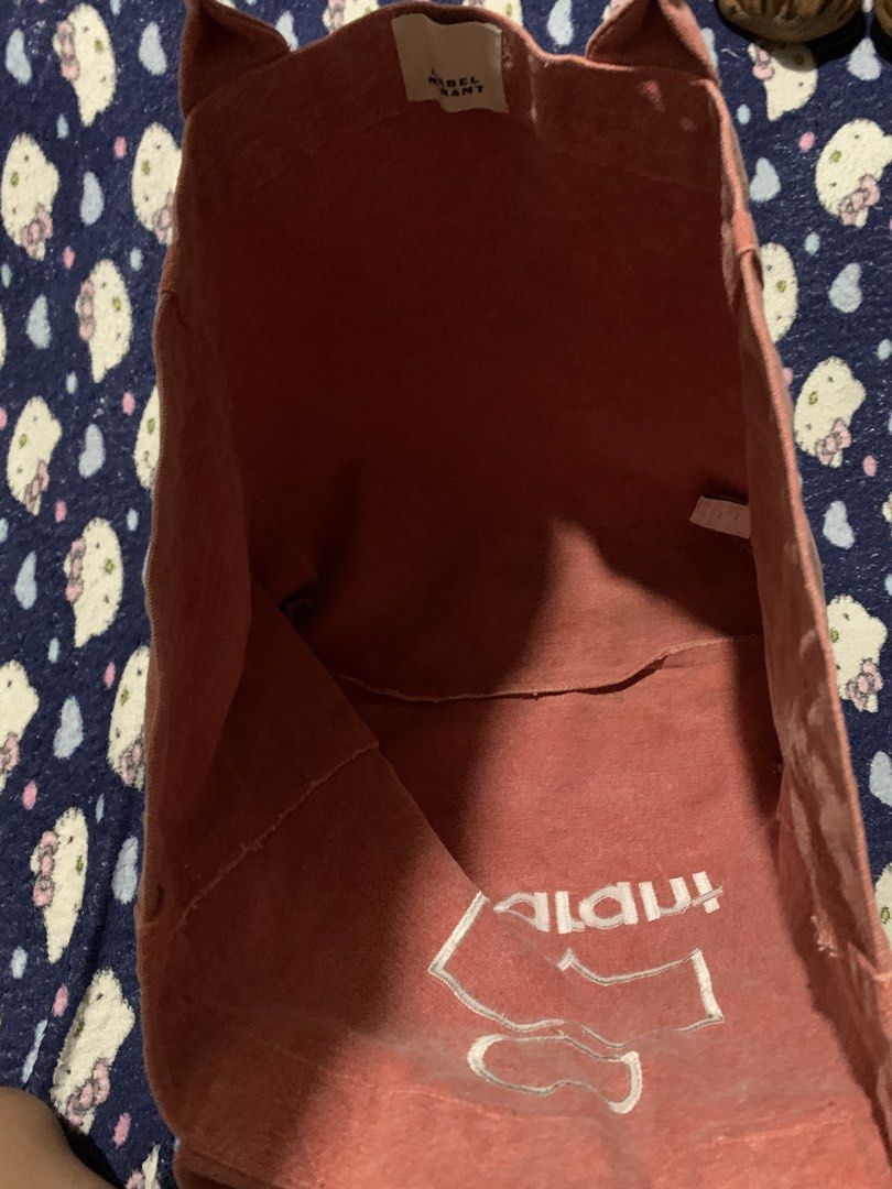 Isabel Marant Pink Canvas Tote Bag (Category: Tote Bags) located in Cebu City. Submitted by jkeive (Listing ID 1441498771, Image 3). Description: - Authentic pink Isabel Marant canvas tote bag - Features the signature Isabel Marant logo on the front - Spacious interior, ideal for everyday essentials - Durable and sturdy handles -Issue See last photo.