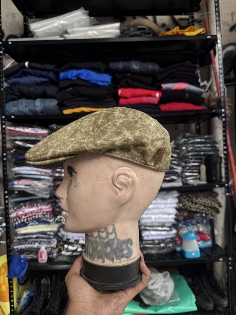Kangol Flat Cap Hat Olive Green Patterned (Category: Caps & Hats) located in Pasig City. Submitted by dripthrift1600 (Listing ID 1441449324, Image 3). Description: - Olive green Kangol flat cap - Features a cool all-over patterned texture - Leather tab on the side with Kangol logo - Adds a stylish touch to any outfit - Looks great from all angles.