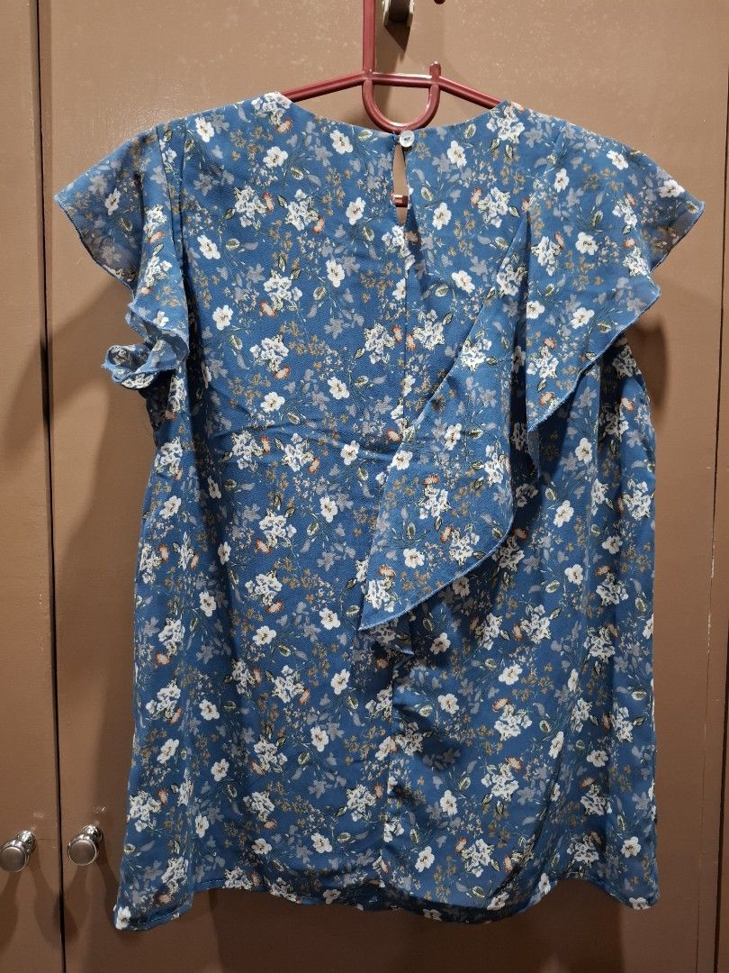 Krizia Blue Floral Ruffle Top Size S (Category: Blouses) located in San Juan City. Submitted by xiobe (Listing ID 1441397220, Image 3). Description: - Pretty blue top with white and orange floral print - Features charming ruffle details on the front - Estimated size: Small (S) - Versatile for casual outings or dressing up.