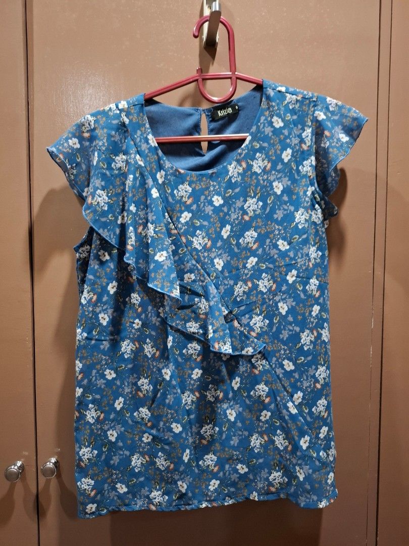 Krizia Blue Floral Ruffle Top Size S (Category: Blouses) located in San Juan City. Submitted by xiobe (Listing ID 1441397220, Image 1). Description: - Pretty blue top with white and orange floral print - Features charming ruffle details on the front - Estimated size: Small (S) - Versatile for casual outings or dressing up.