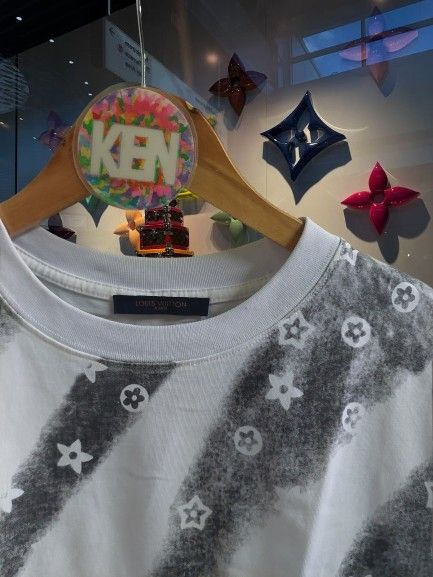 Louis Vuitton Dimes T-Shirt (Category: Tshirts & Polo Shirts ) located in Quezon City. Submitted by finds2026 (Listing ID 1441432456, Image 2). Description: - White Louis Vuitton T-shirt - Grey graphic print with LV monogram flowers - Size: 19.5x26 - Condition: Good - Versatile: Pairs well with jeans or shorts - Classic Louis Vuitton piece.