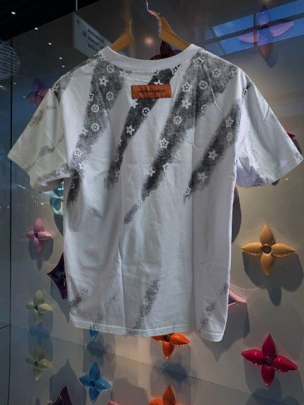 Louis Vuitton Dimes T-Shirt (Category: Tshirts & Polo Shirts ) located in Quezon City. Submitted by finds2026 (Listing ID 1441432456, Image 3). Description: - White Louis Vuitton T-shirt - Grey graphic print with LV monogram flowers - Size: 19.5x26 - Condition: Good - Versatile: Pairs well with jeans or shorts - Classic Louis Vuitton piece.