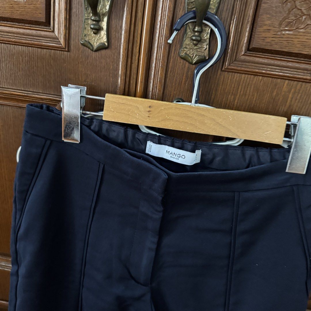 Mango Basic Navy Blue Tailored Pants (Category: Other Bottoms) located in Quezon City. Submitted by kb0030 (Listing ID 1441387623, Image 2). Description: - Brand: Mango Basic - Color: Navy Blue - Style: Tailored Pants - Length: Cropped - Fit: Clean, modern cut - Features: Subtle front and back leg seam detailing, elasticated waistband for comfort - Versatility: Ideal for both work and casual outfits.