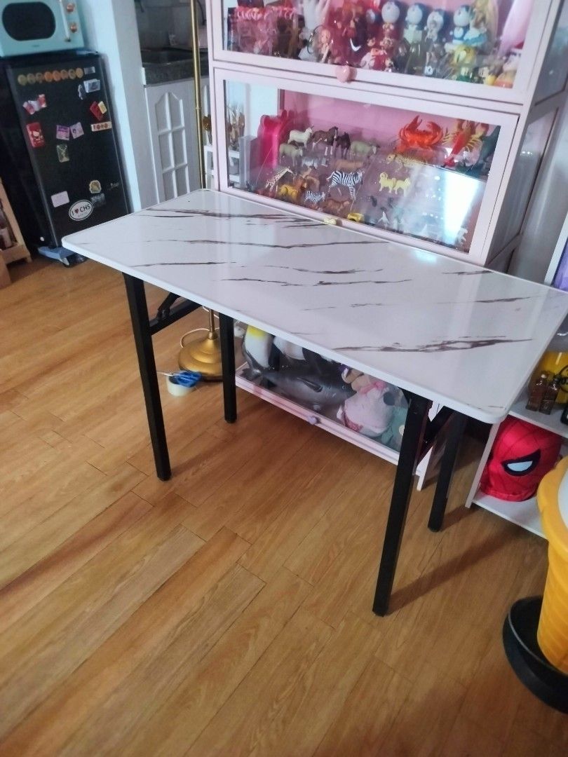 Marble Top Folding Table (Category: Tables & Sets) located in Bulacan. Submitted by nathariashoppe (Listing ID 1441413913, Image 1). Description: 50cm width 100cm length - Sturdy folding table - Marble-effect top - Black metal legs that fold flat - Ideal for extra dining space, study desk, or craft table - Compact and practical design - Ready for a new home.