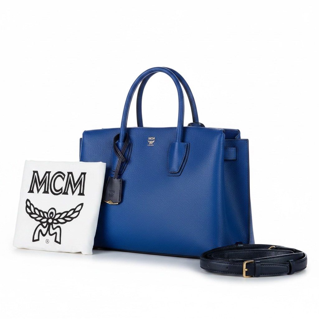 Authentic Blue Milla Leather Sateel Tote Bag (Category: Luxury Bags & Wallets) located in Balanga. Submitted by forevercloset.new (Listing ID 1441523834, Image 2). Description: - Preloved MCM Milla tote bag - Vibrant blue color - Made from pony-style calfskin leather - Top handles and detachable shoulder strap - Interior with multiple compartments for organization - Includes original MCM dust bag - Versatile for everyday use or special occasions 