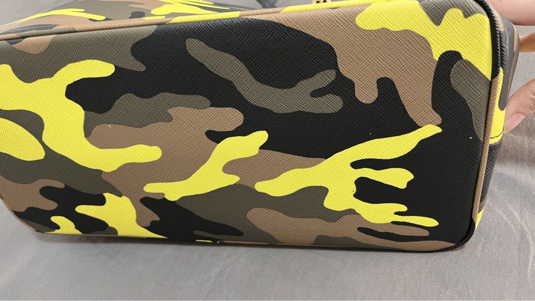 Michael Kors Camouflage Tote Bag (Category: Luxury Bags & Wallets) located in Pasig City. Submitted by declutter.n.sell (Listing ID 1441430703, Image 3). Description: - Stylish Michael Kors tote bag - Cool camouflage print (yellow, brown, black, green) - Black leather straps and trim - Signature gold MK logo charm - Spacious interior for essentials - Ideal for everyday use or travel Pickup loc. Ortigas Center Pasig.