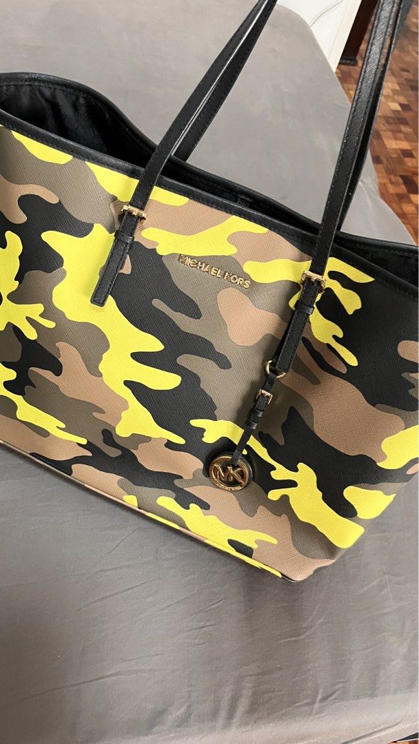 Michael Kors Camouflage Tote Bag (Category: Luxury Bags & Wallets) located in Pasig City. Submitted by declutter.n.sell (Listing ID 1441430703, Image 1). Description: - Stylish Michael Kors tote bag - Cool camouflage print (yellow, brown, black, green) - Black leather straps and trim - Signature gold MK logo charm - Spacious interior for essentials - Ideal for everyday use or travel Pickup loc. Ortigas Center Pasig.
